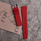 Fluororubber diving watch strap band in red with silver buckle, close-up detail view