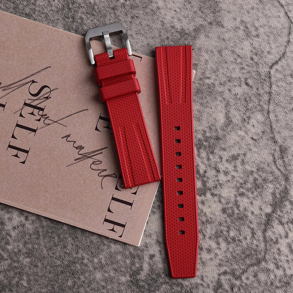 Fluororubber diving watch strap band in red with silver buckle, close-up detail view