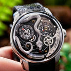 Lucky Harvey ZLS203-2 silver snake automatic watch held in hand lifestyle scene with greenery