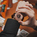 Lucky Harvey ZLS302-2 rose gold poker roulette automatic watch worn on a wrist holding playing cards