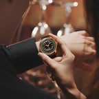 Lucky Harvey ZLS303-1 European Roulette watch held in hand in bar setting with wine glass bokeh