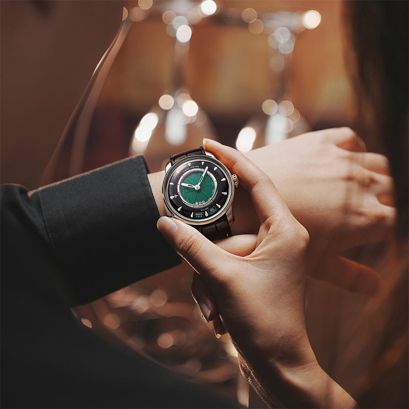 Lucky Harvey ZLS304-1 green Sic Bo automatic watch worn on wrist in warm lifestyle scene with bokeh lights