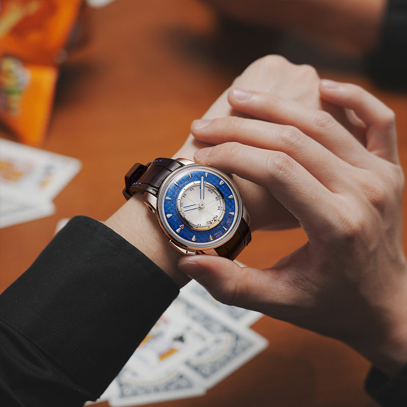 Lucky Harvey ZLS304-2 blue Sic Bo automatic watch worn on wrist over playing cards