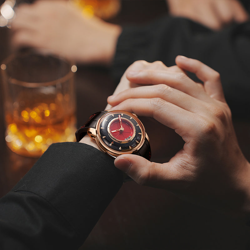 Lucky Harvey ZLS304-3 red rose gold Sic Bo automatic watch worn on wrist beside whiskey glass