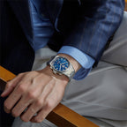 Lucky Harvey ZLS402-1 ocean blue chiming watch worn on a man's wrist in a blue suit