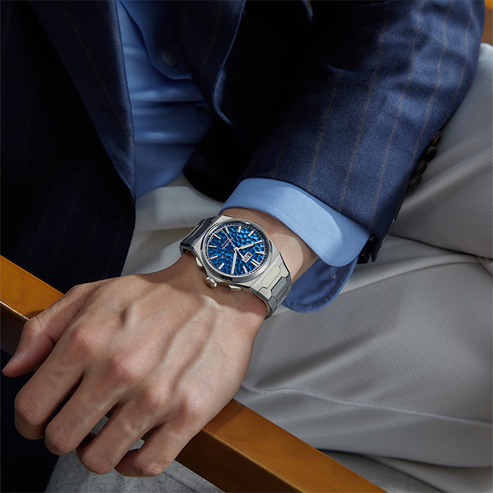 Lucky Harvey ZLS402-1 ocean blue chiming watch worn on a man's wrist in a blue suit