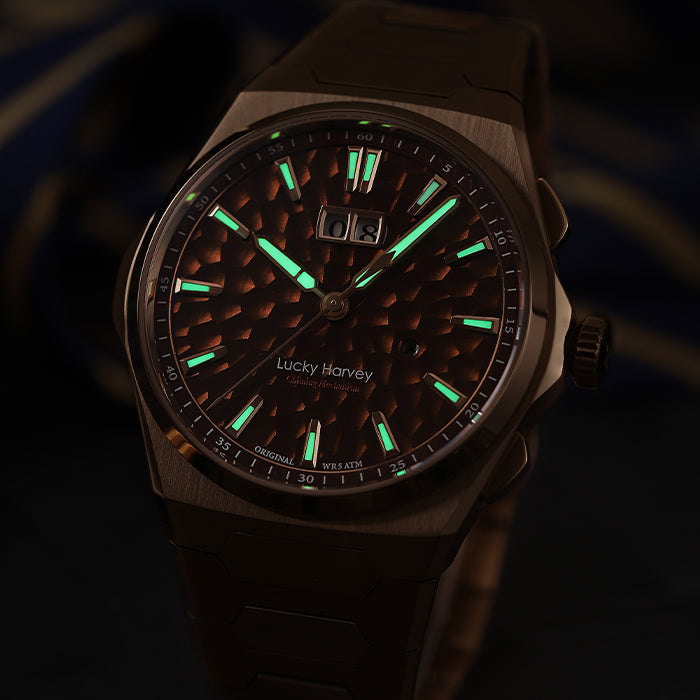Lucky Harvey ZLS402-3 rose gold watch with green lume glowing in night scene