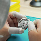 Lucky Harvey ZLS402-3 watchmaker holding cased chiming movement in cleanroom