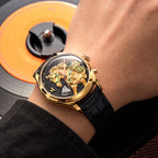 Lucky Harvey ZLS502-3 gold horse automatic watch worn on a wrist with vinyl record in background