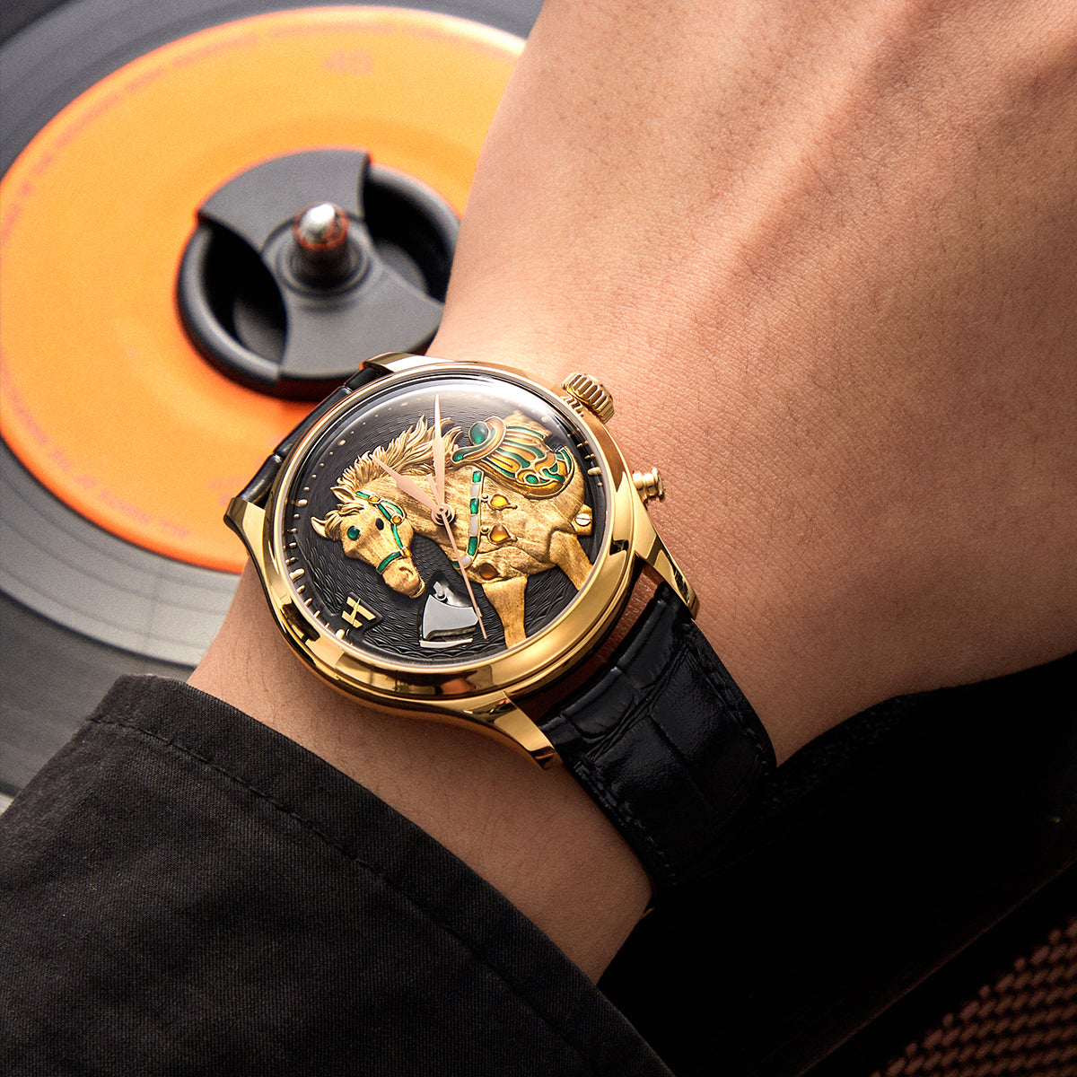 Lucky Harvey ZLS502-3 gold horse automatic watch worn on a wrist with vinyl record in background