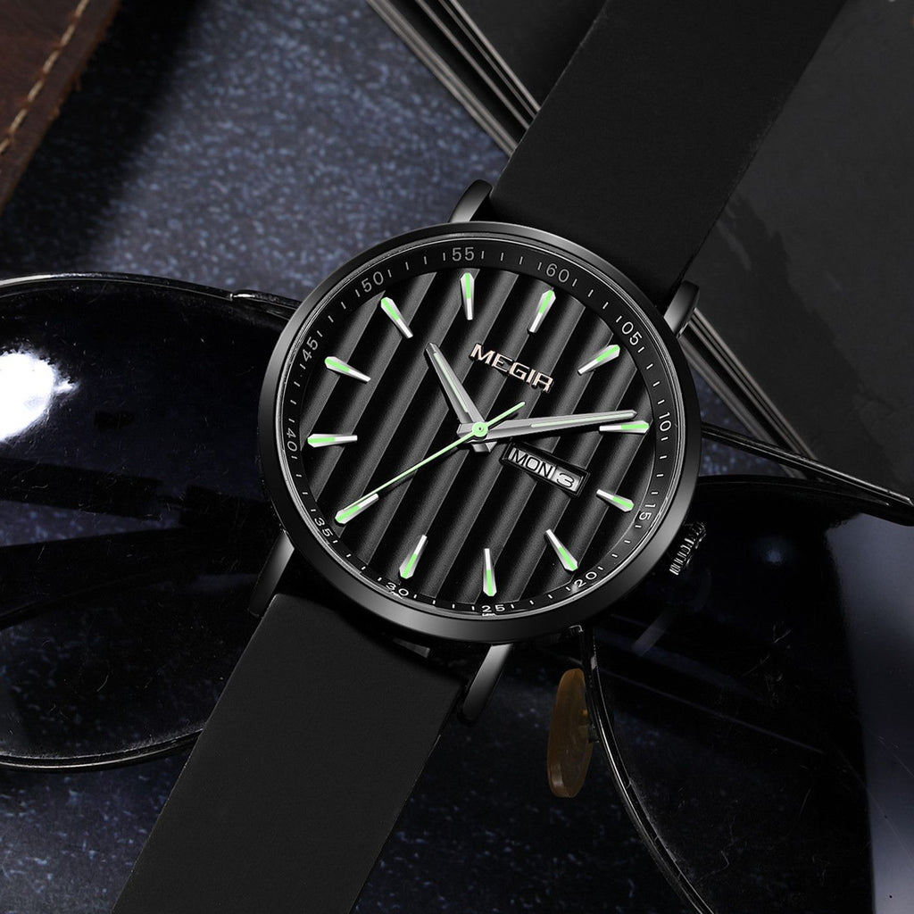 MEGIR 1081 men's watch, black fluted dial and black case on a black strap, resting beside sunglasses