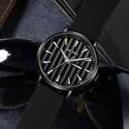 MEGIR 1081 men's watch, black fluted dial and black case on a black strap, resting beside sunglasses