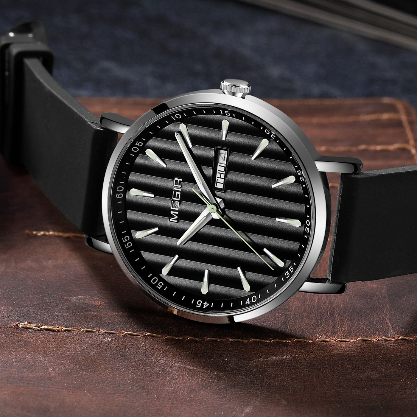 MEGIR 1081 men's watch, black fluted dial, silver-tone case and black strap on a leather surface
