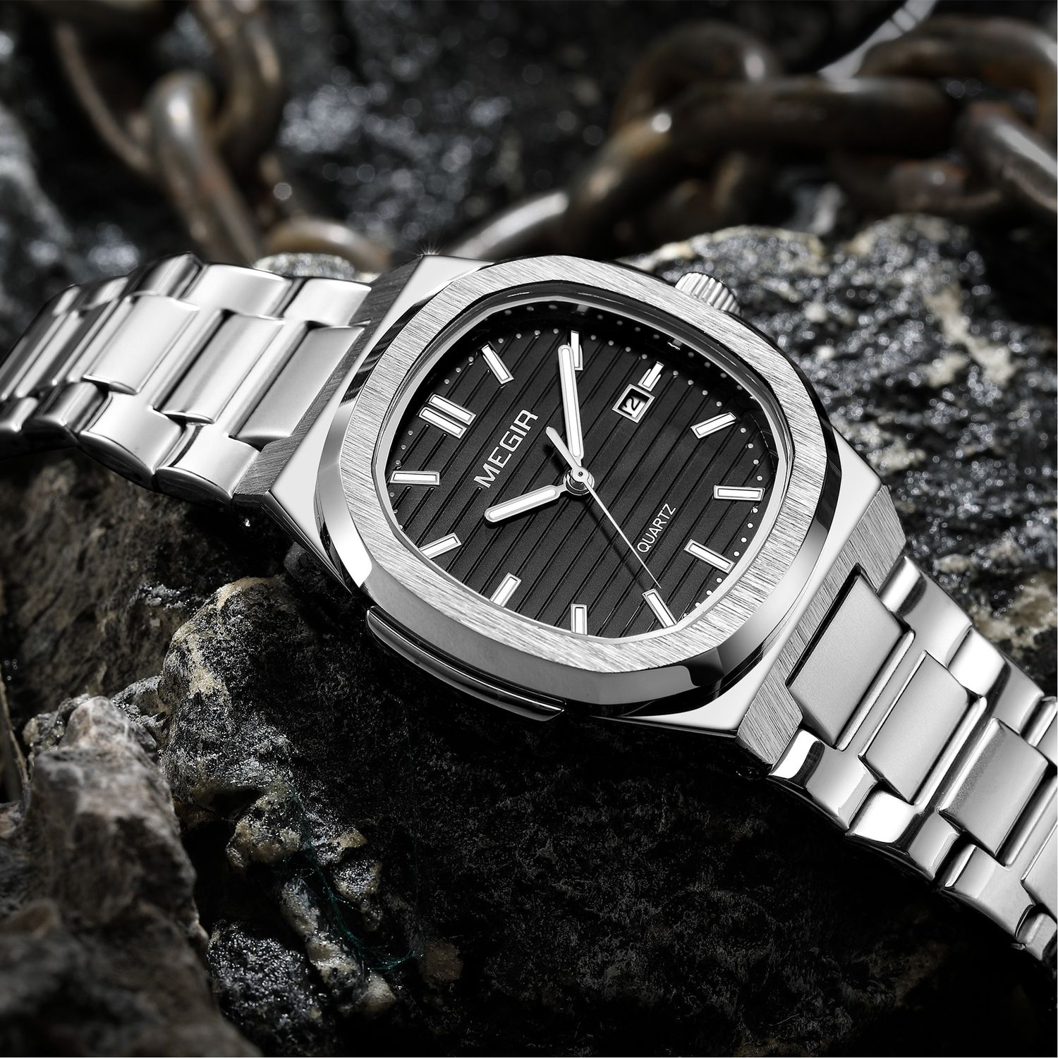 MEGIR 1084 women's watch, black grooved dial and octagonal bezel on a silver-tone bracelet, resting on stone