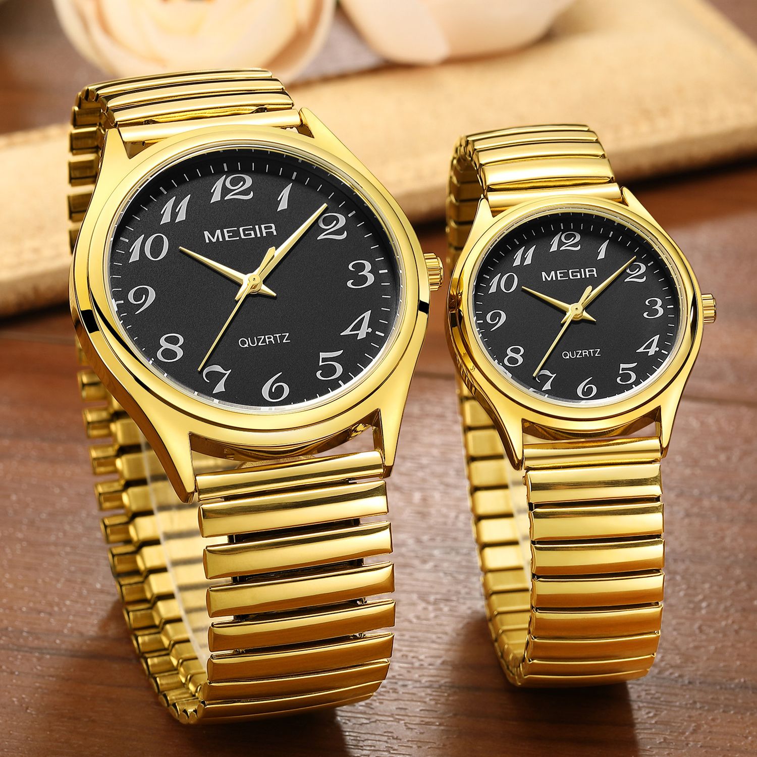 MEGIR 1088 unisex watch pair in gold-tone with black Arabic-numeral dials and stretch bracelets