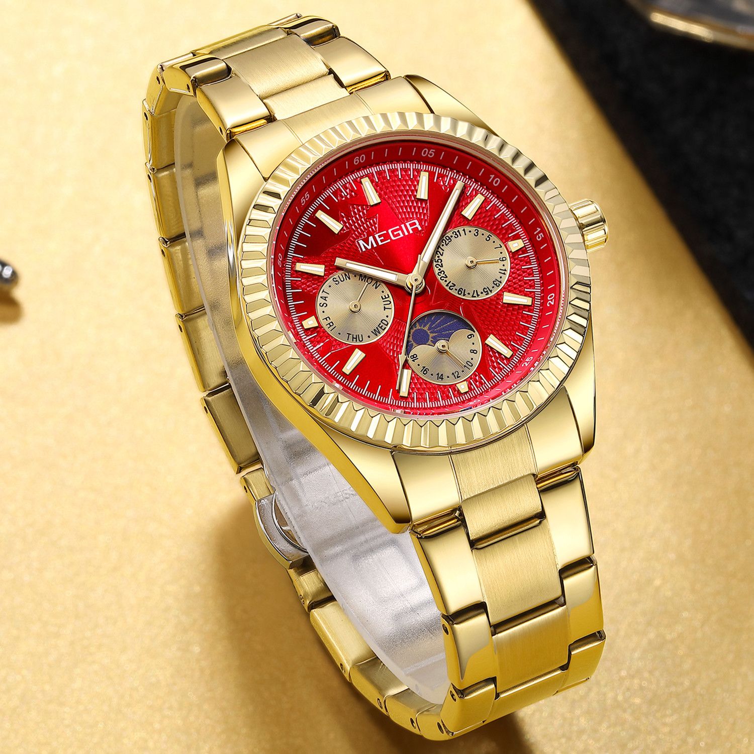 MEGIR 1102 men's multifunction watch, gold case with red moon-phase dial and gold steel bracelet, angled view