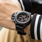 MEGIR 2002 men's chronograph watch on the wrist, black case with black dial and black silicone strap, close-up
