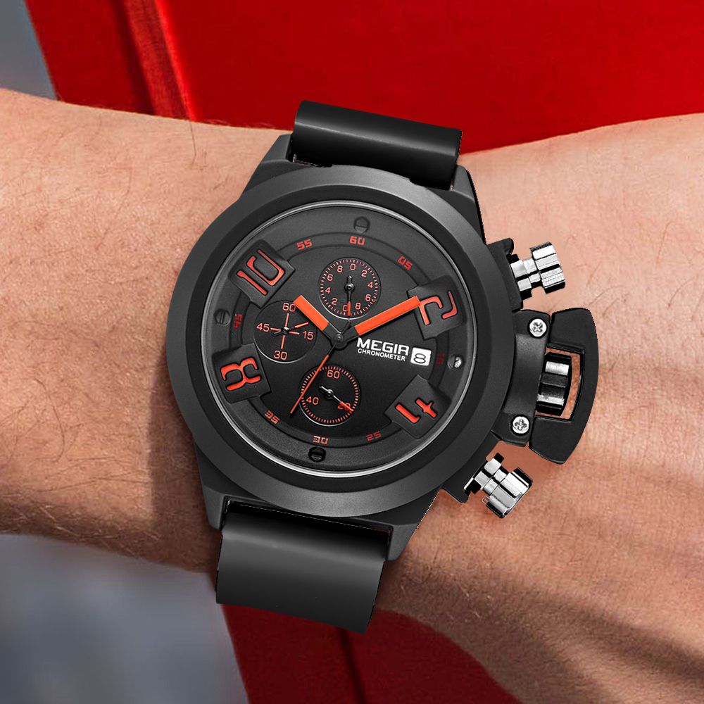 MEGIR 2002 men's chronograph watch on the wrist, black case with black dial, orange accents and black silicone strap