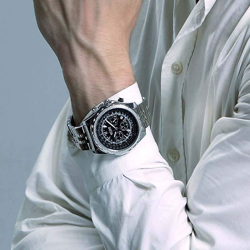 MEGIR 2006 men's chronograph watch on the wrist, silver case with black dial and steel bracelet