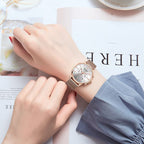 MEGIR 2011 women's chronograph watch on the wrist, rose-gold case with white dial and mesh bracelet, close-up