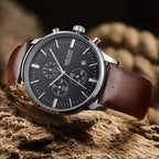 MEGIR 2011 men's chronograph watch, silver case with black dial and brown leather strap, three-quarter view