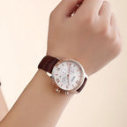 MEGIR 2012 men's chronograph watch on the wrist, rose-gold case with white dial and brown leather strap, close-up