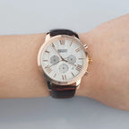 MEGIR 2012 men's chronograph watch on the wrist, rose-gold case with white dial and brown leather strap
