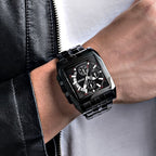 MEGIR 2018 men's chronograph watch on the wrist, all-black rectangular case with black dial and steel bracelet