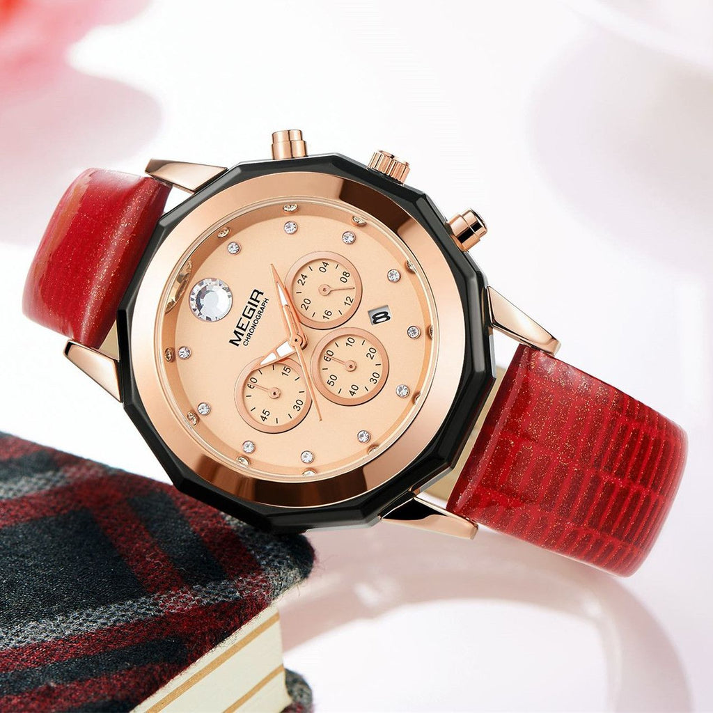 MEGIR 2042 women's chronograph watch, rose-gold dial with crystal markers and red leather strap, angled view