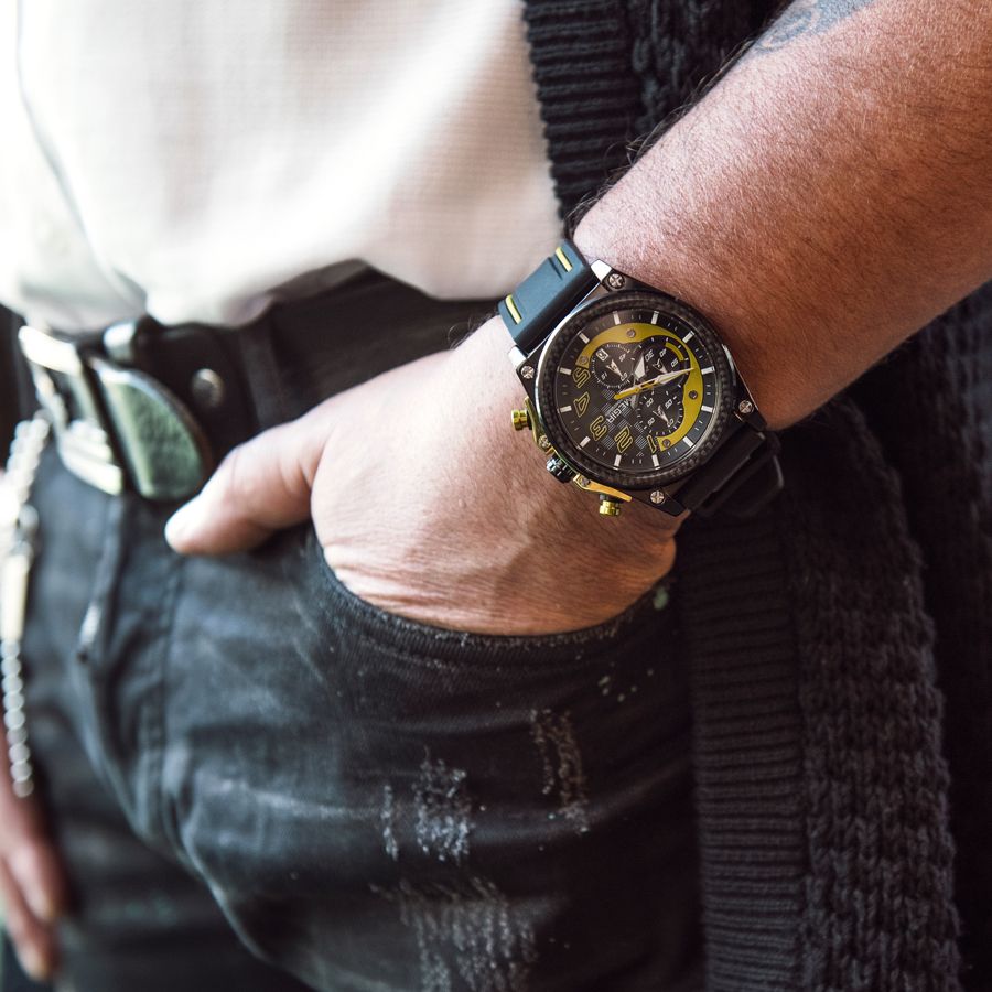 MEGIR 2051 men's chronograph watch on the wrist, black case with yellow accents and black silicone strap, close-up