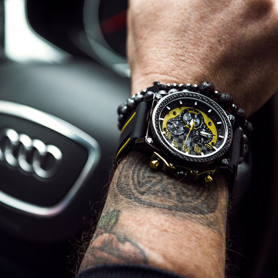 MEGIR 2051 men's chronograph watch on the wrist, black case with yellow accents and black silicone strap
