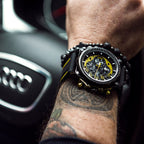 MEGIR 2051 men's chronograph watch on the wrist, black case with yellow accents and black silicone strap