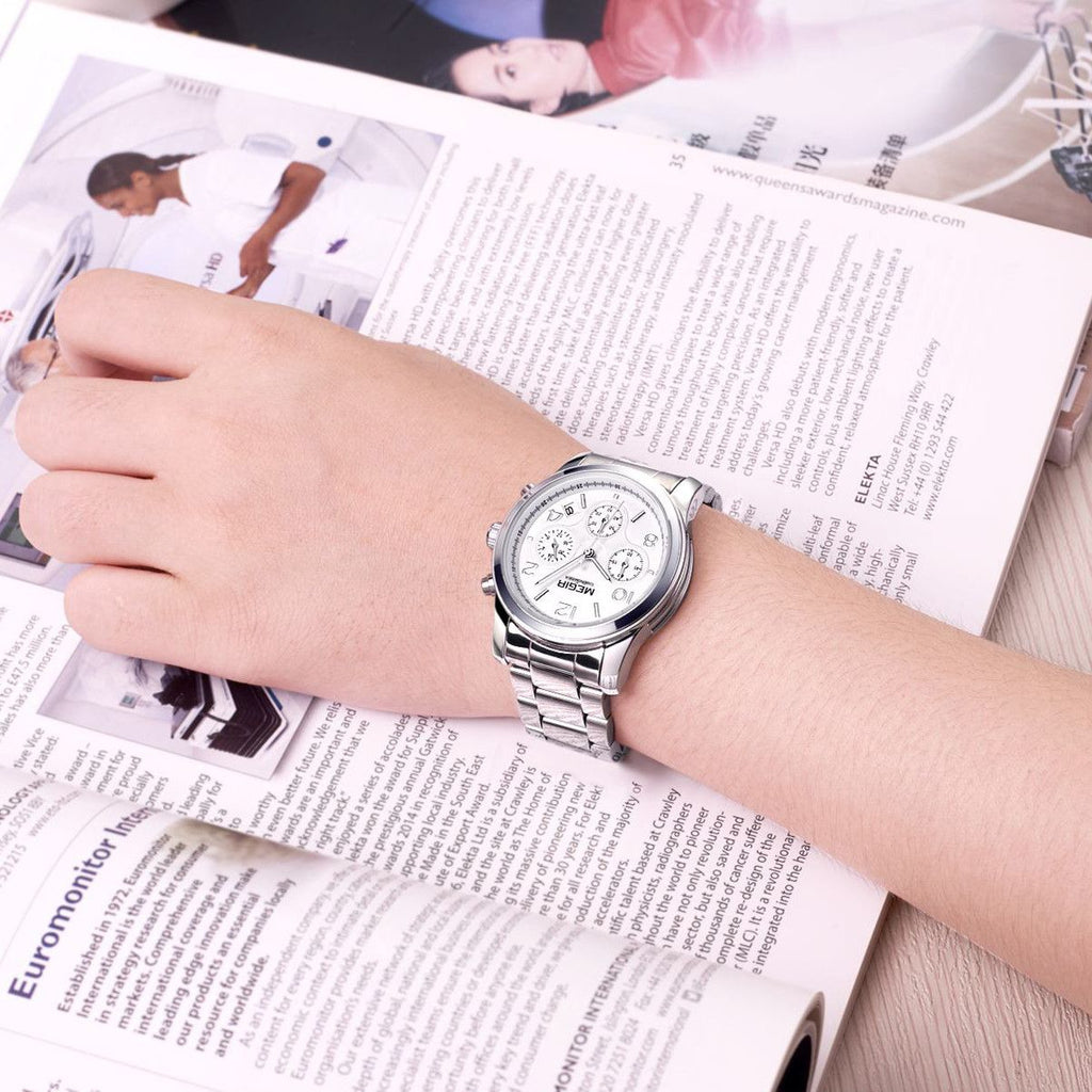 MEGIR 2057 women's chronograph watch on the wrist, silver case with white dial and stainless steel bracelet, close-up