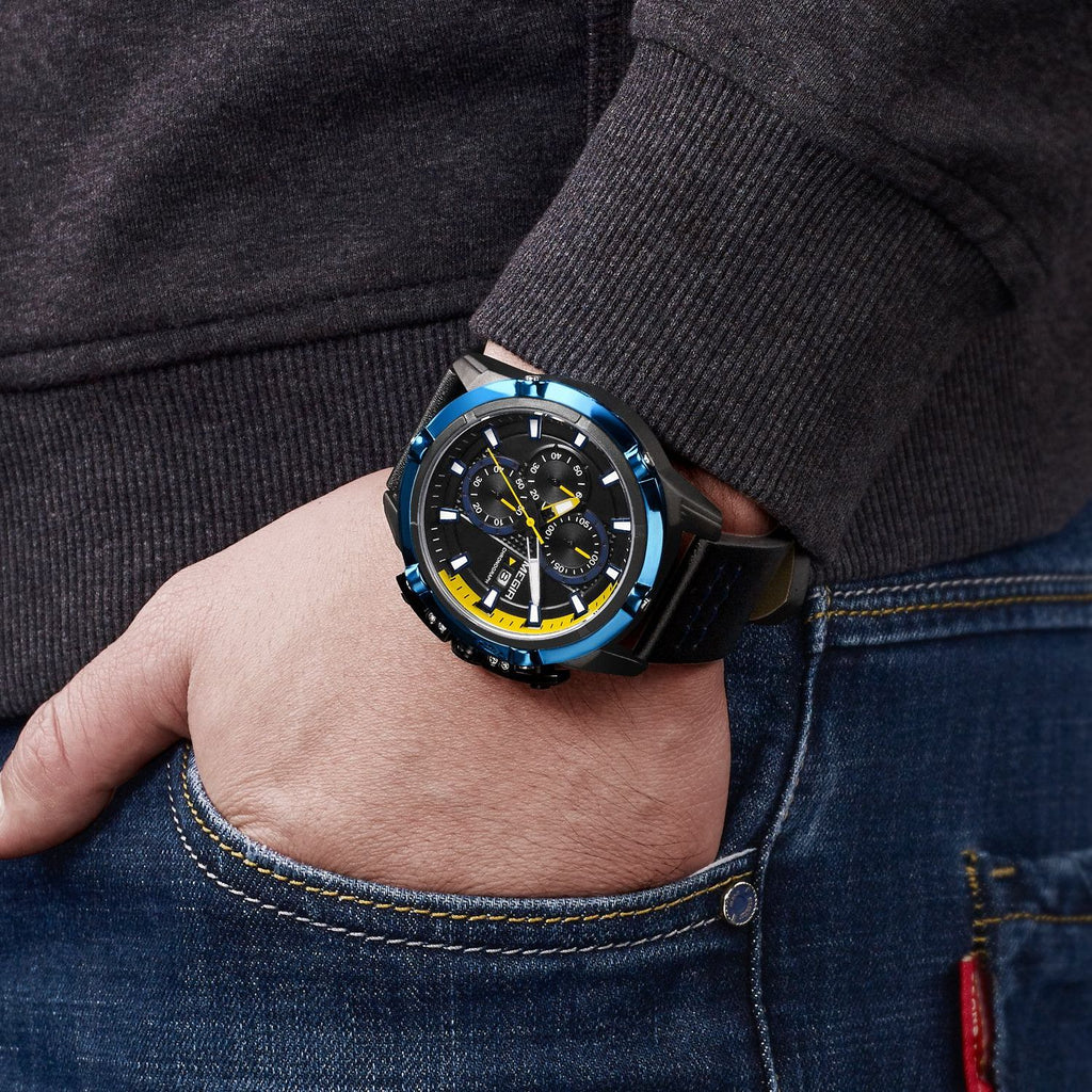MEGIR 2062 men's chronograph watch on the wrist, black case with blue bezel, yellow accents and black leather strap