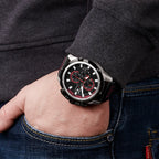 MEGIR 2062 men's chronograph watch on the wrist, silver case with black dial and red accents, close-up