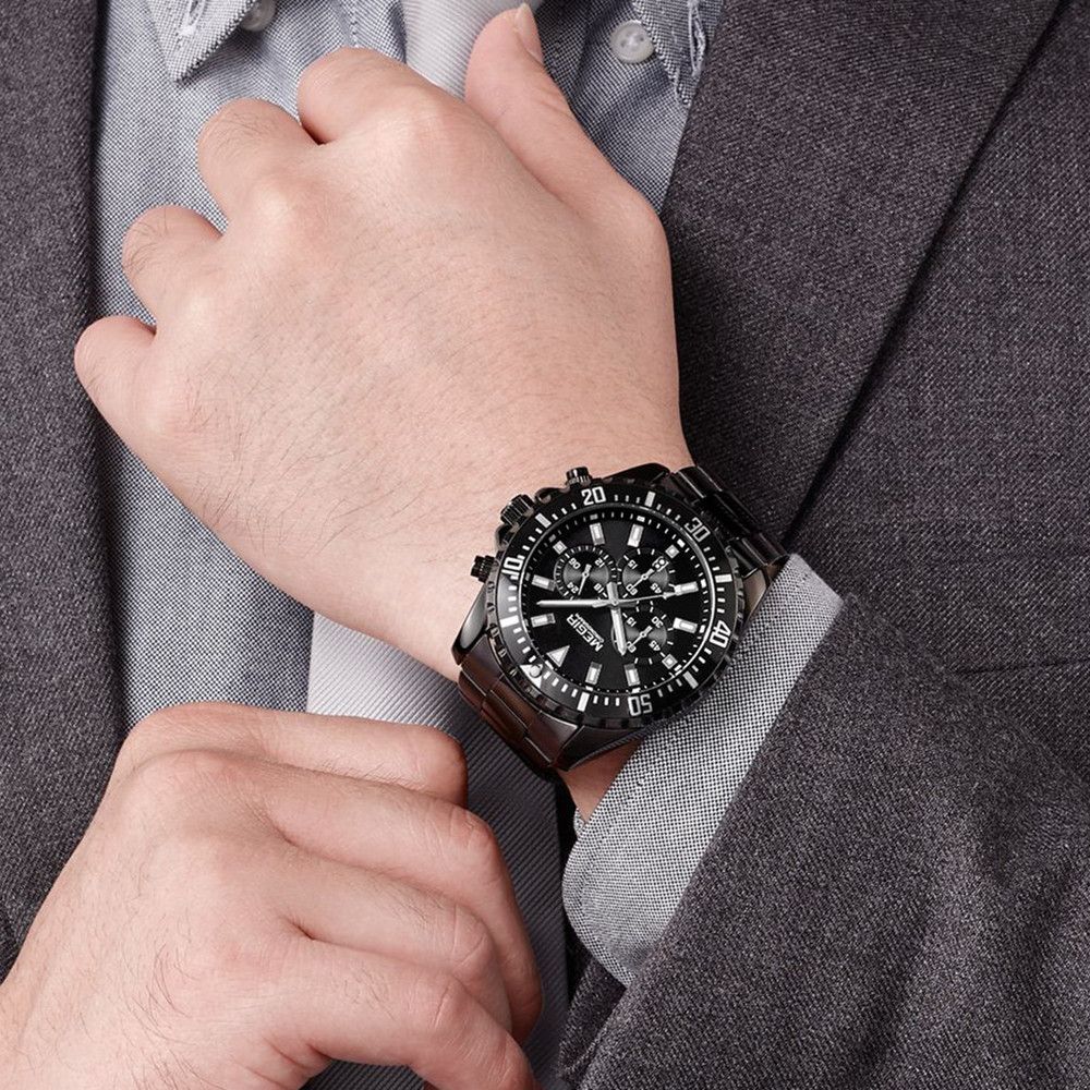 MEGIR 2064 men's chronograph watch on the wrist, all-black case with black dial and black stainless steel bracelet