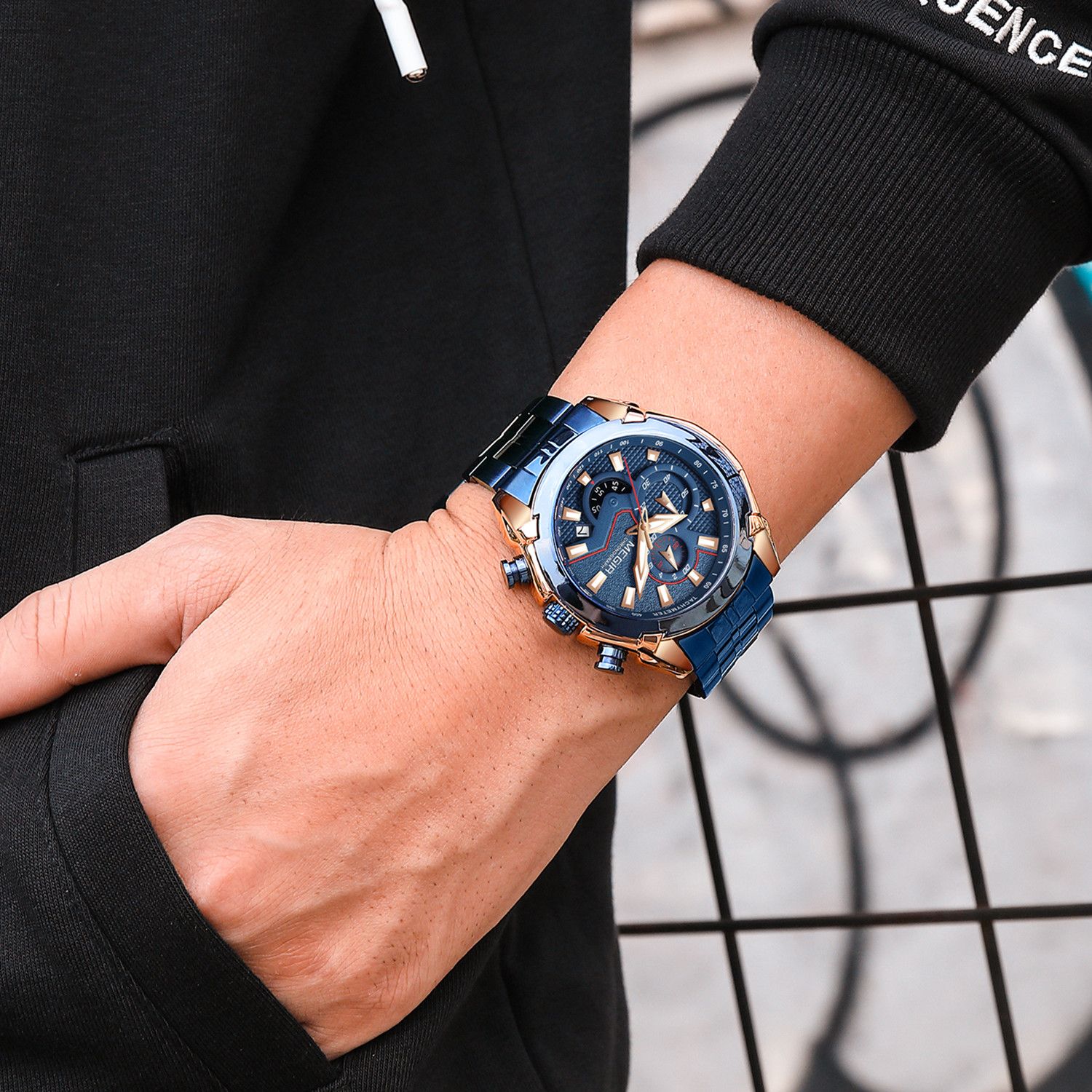 MEGIR 2065 men's chronograph watch on the wrist, blue case with blue dial and blue steel bracelet, close-up