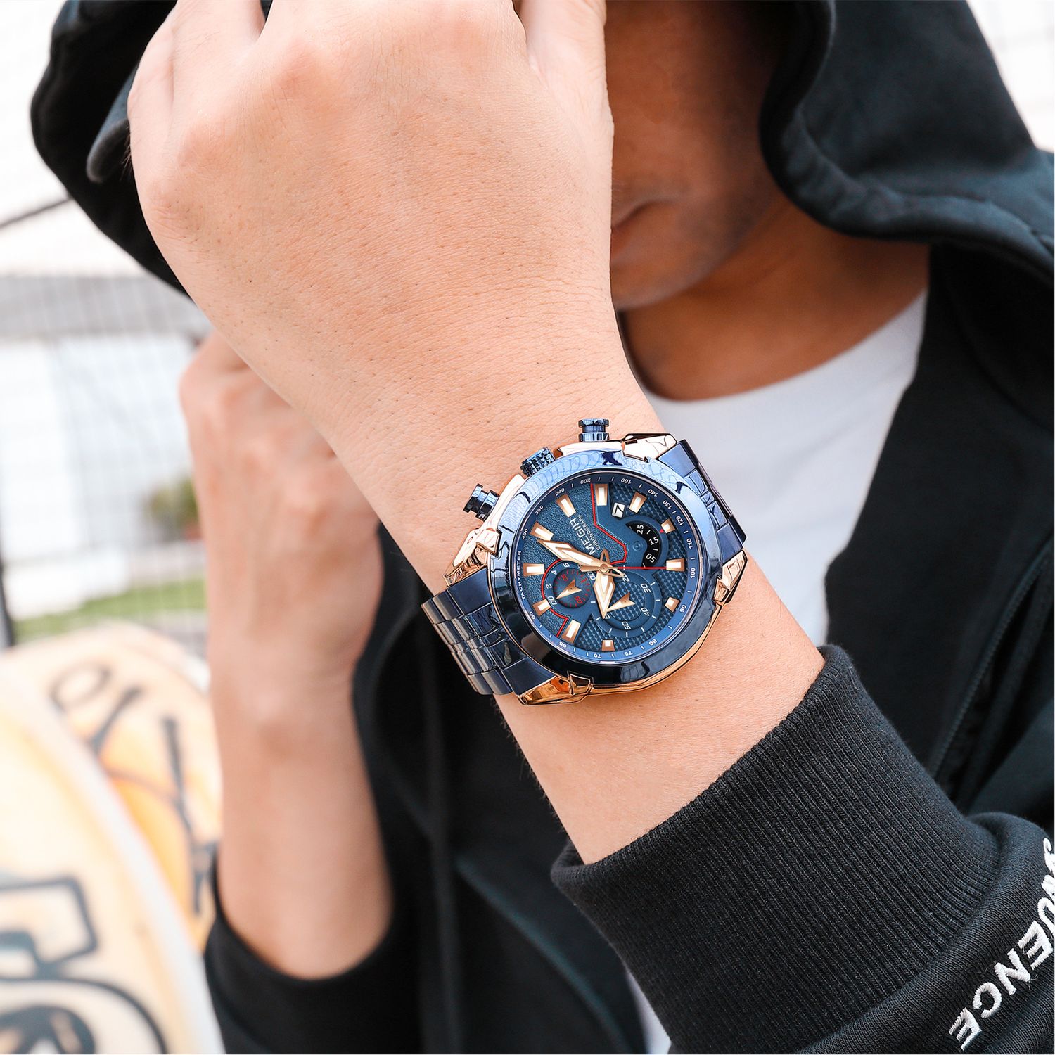 MEGIR 2065 men's chronograph watch on the wrist, rose-gold and blue case with blue dial and blue steel bracelet