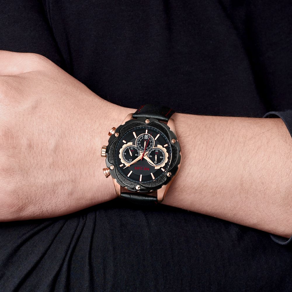 MEGIR 2070 men's chronograph watch on the wrist, rose-gold case with black dial and black leather strap, close-up