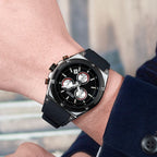 MEGIR 2073 men's chronograph watch on the wrist, silver case with black dial and black silicone strap, close-up