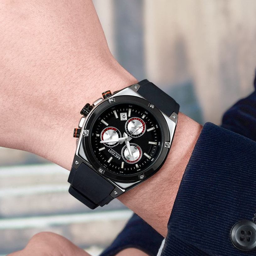 MEGIR 2073 men's chronograph watch on the wrist, silver case with black dial and black silicone strap, close-up