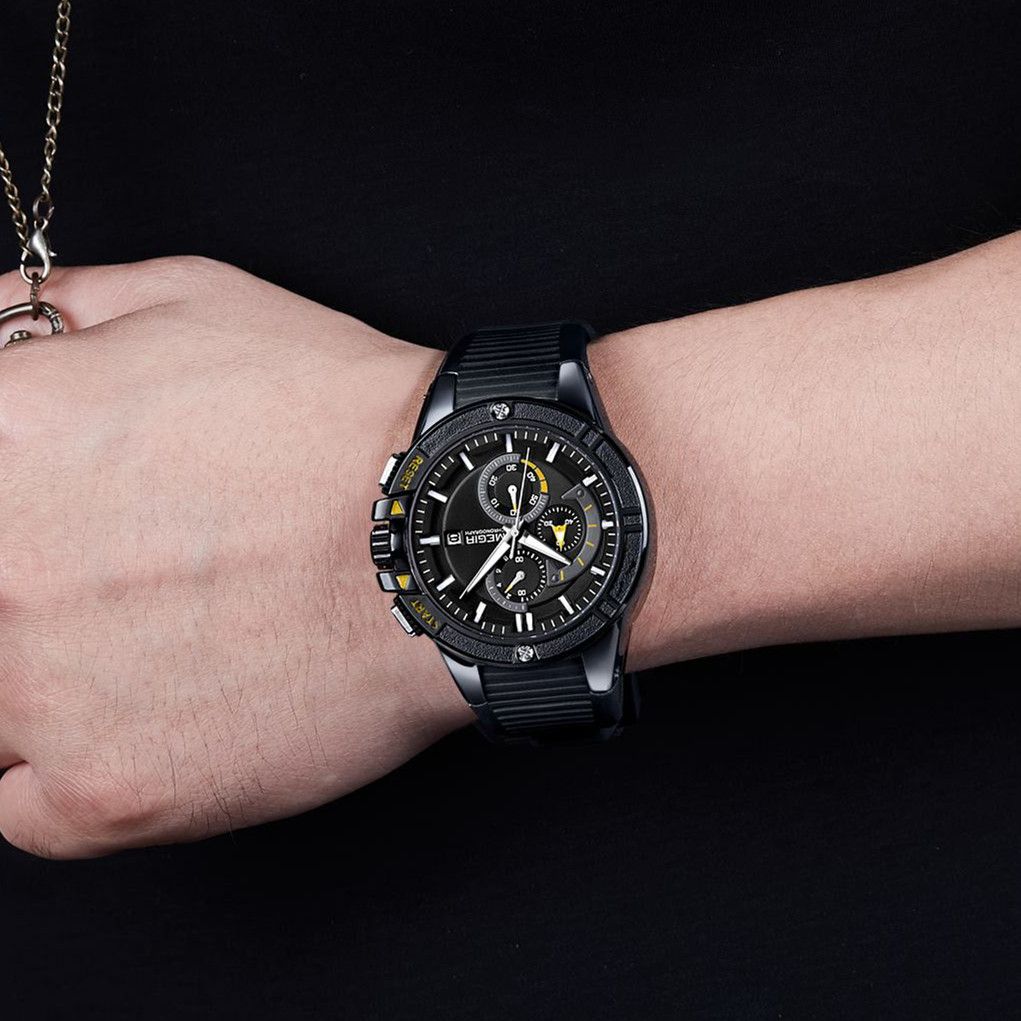 MEGIR 2095 men's chronograph watch on the wrist, black case with black dial, yellow accents and black silicone strap