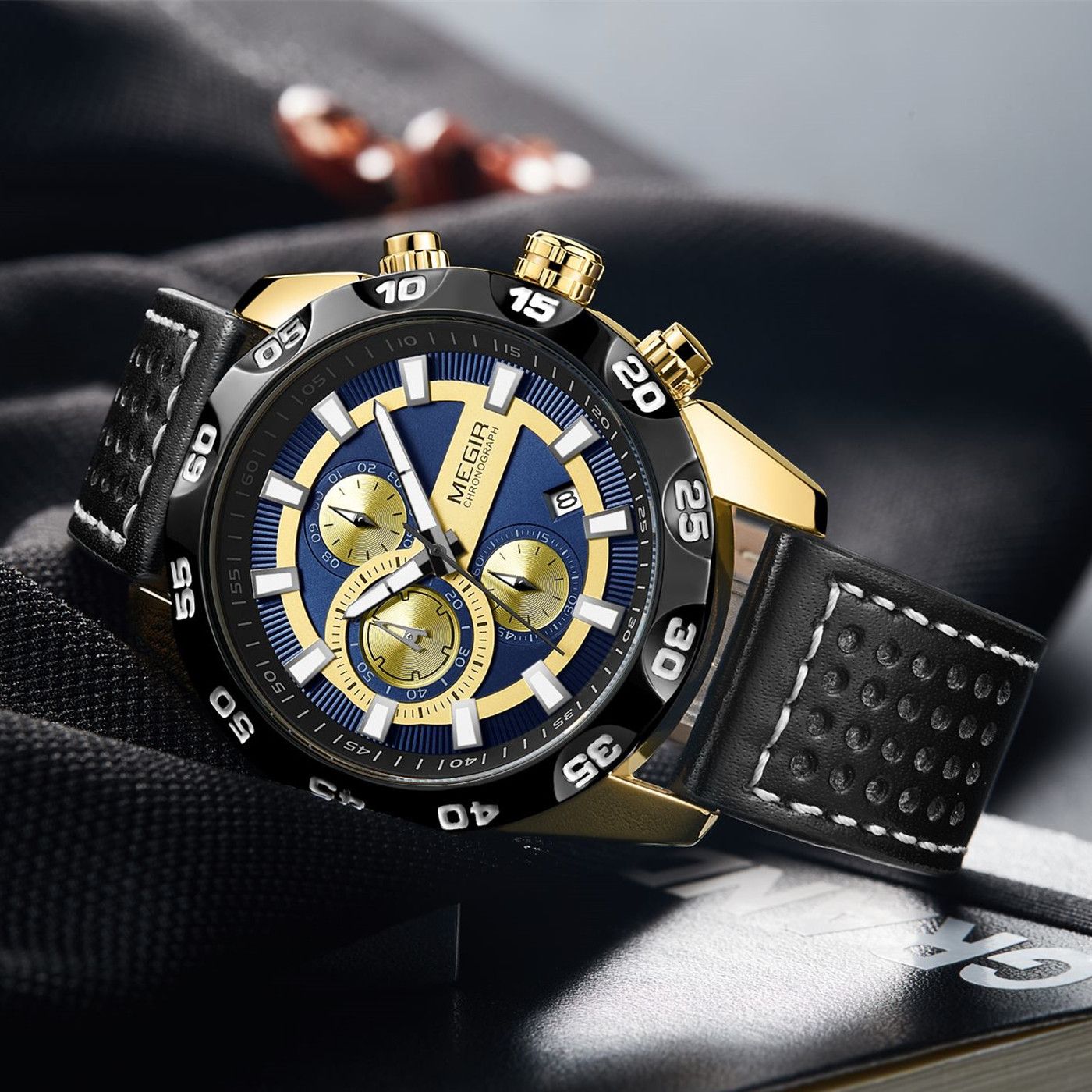 MEGIR 2096 men's chronograph watch, gold-tone accents with blue and gold dial and black leather strap, angled view