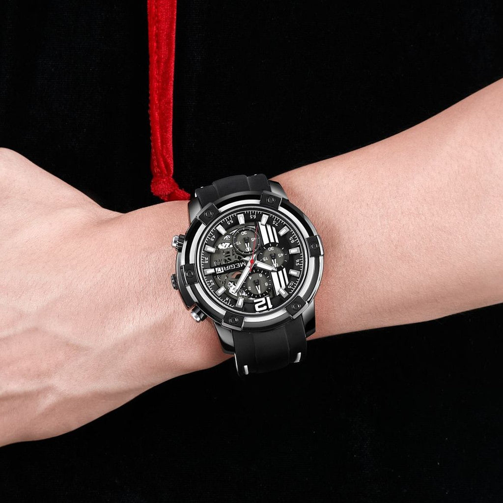 MEGIR 2097 men's chronograph watch on the wrist, black case with black dial, white accents and black silicone strap