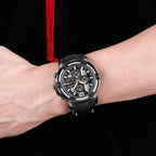MEGIR 2097 men's chronograph watch on the wrist, black case with black dial, white accents and black silicone strap