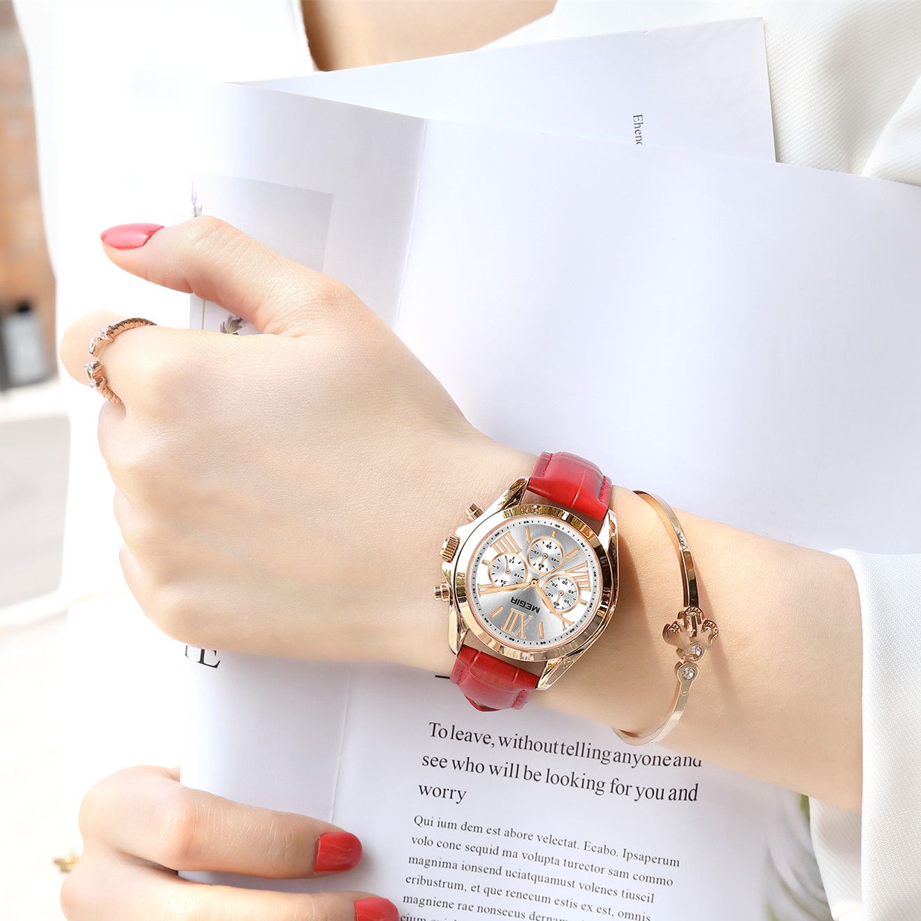 MEGIR 2114 women's chronograph watch on the wrist, rose-gold case with white dial and red leather strap