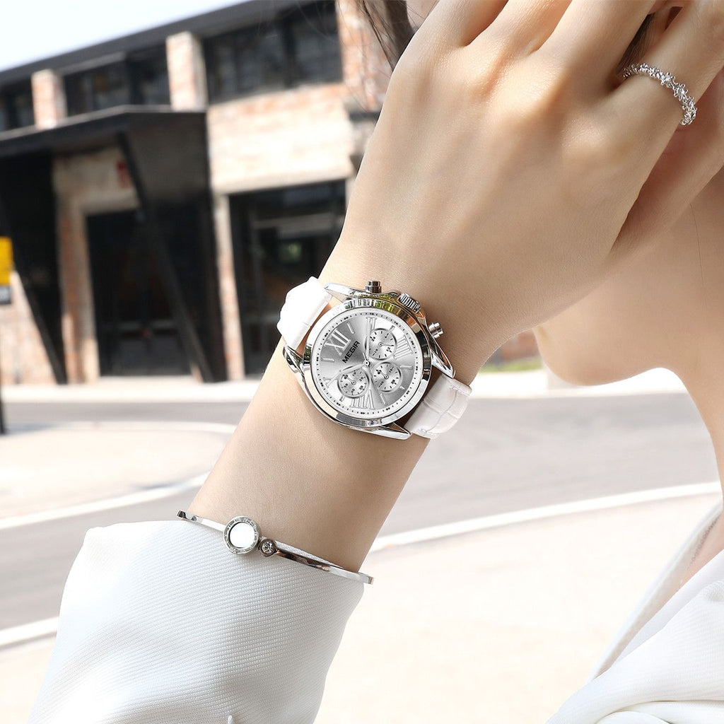 MEGIR 2114 women's chronograph watch on the wrist, silver case with white dial and white leather strap