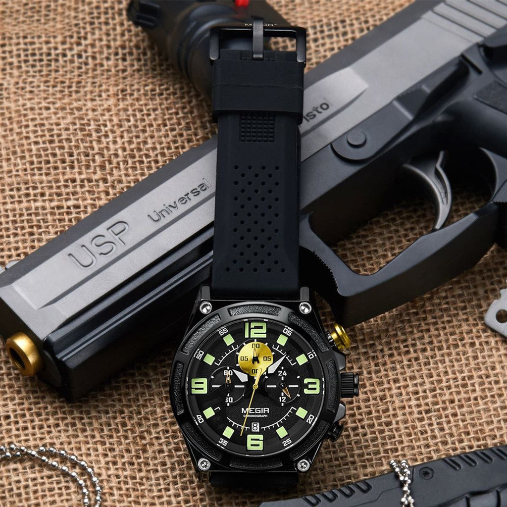 MEGIR 2116 men's chronograph watch, black case with black dial and black silicone strap, shown on a tactical prop