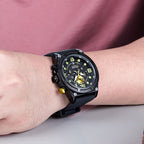 MEGIR 2116 men's chronograph watch on the wrist, black case with black dial, green numerals and black silicone strap