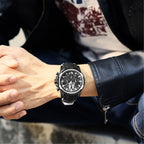 MEGIR 2133 men's chronograph watch on the wrist, black case with silver bezel, black dial and black silicone strap